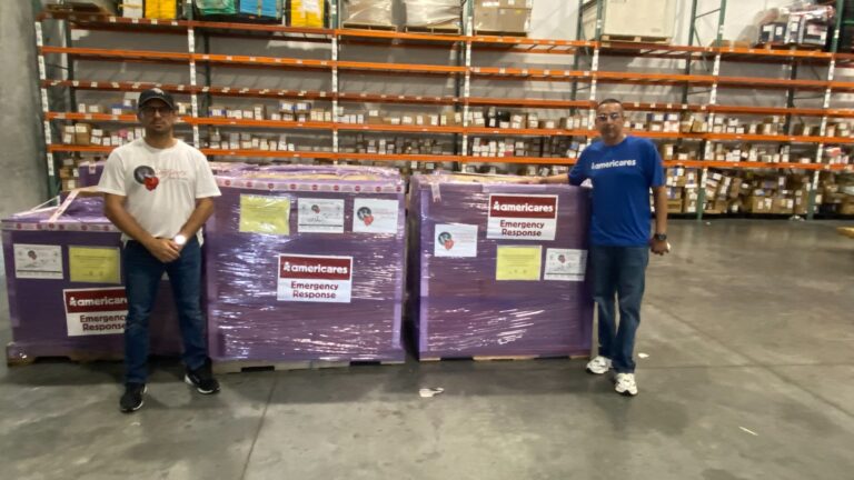 Representatives of Americares and Fundación Corazones por la Vida with five emergency response pallets