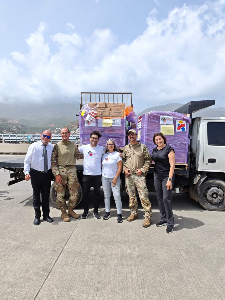 Response partners coordinate beside the received humanitarian pallets at the airport