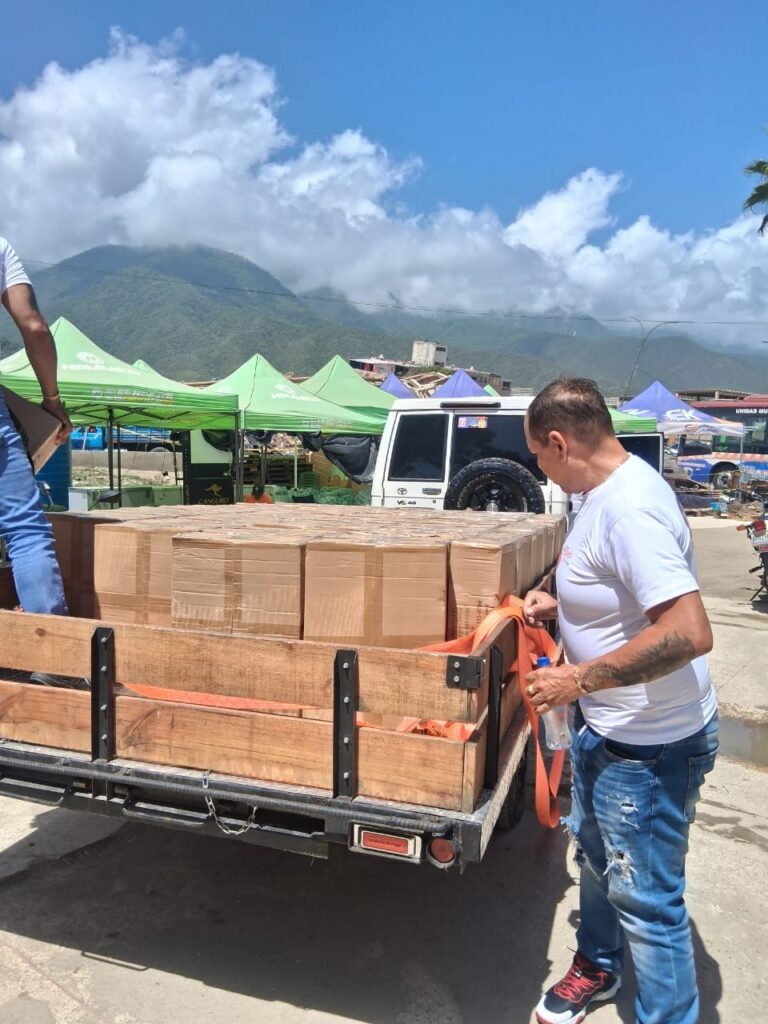 Boxes from the emergency shipment are organized beside a response vehicle