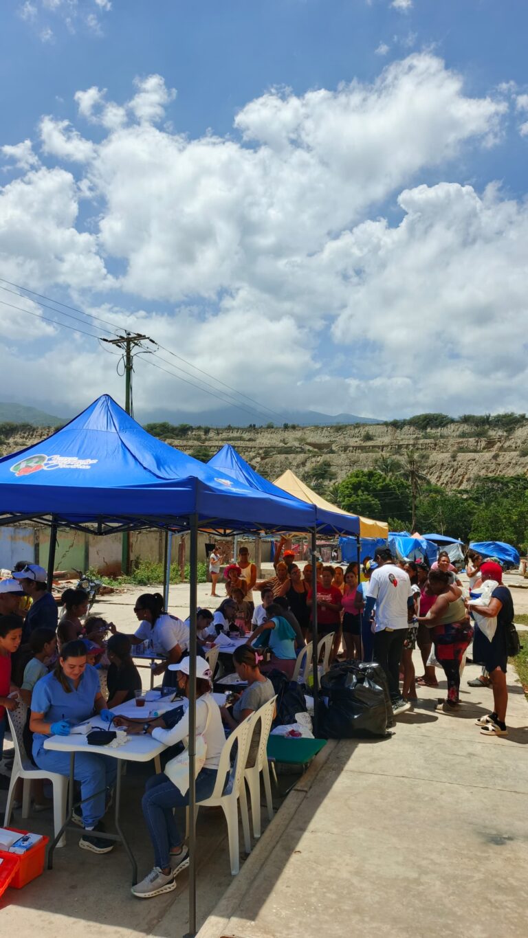 Community members gather at the foundation’s outreach tents in Mare Abajo.