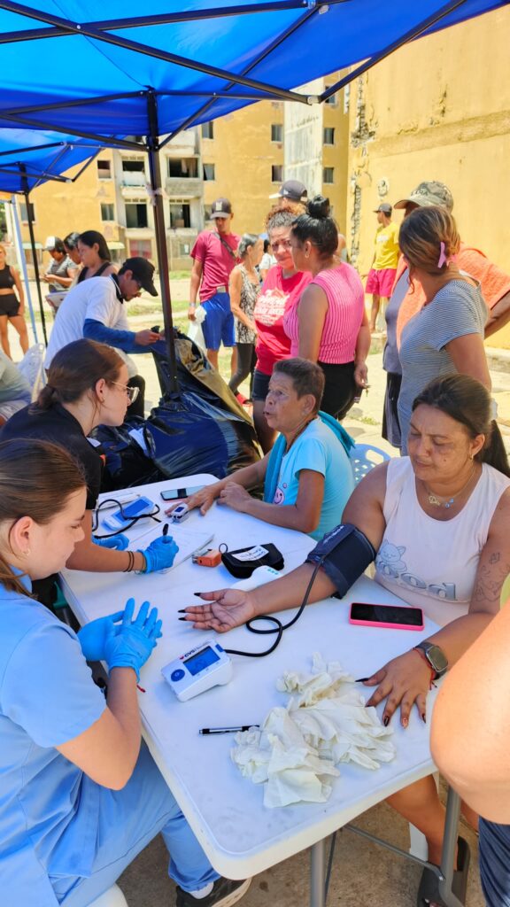 A health worker checks a community member’s blood pressure at the Mare Abajo outreach.