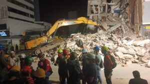 Rescue teams and heavy equipment at night