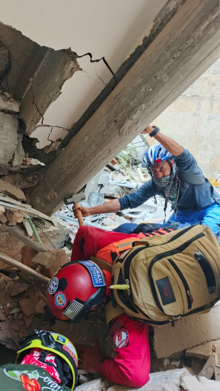 Responders work among earthquake debris