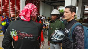A foundation volunteer organizes supplies near other rescuers