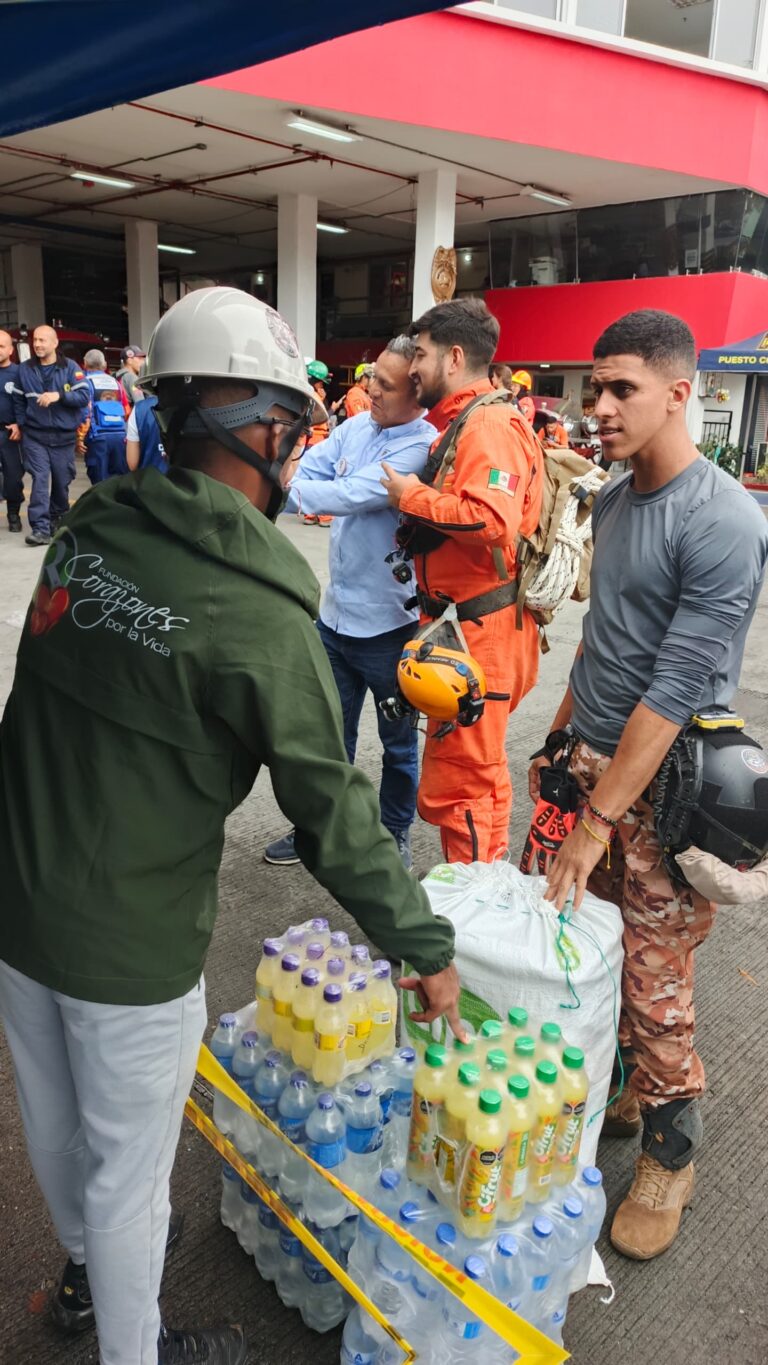 A foundation volunteer delivers water and drinks