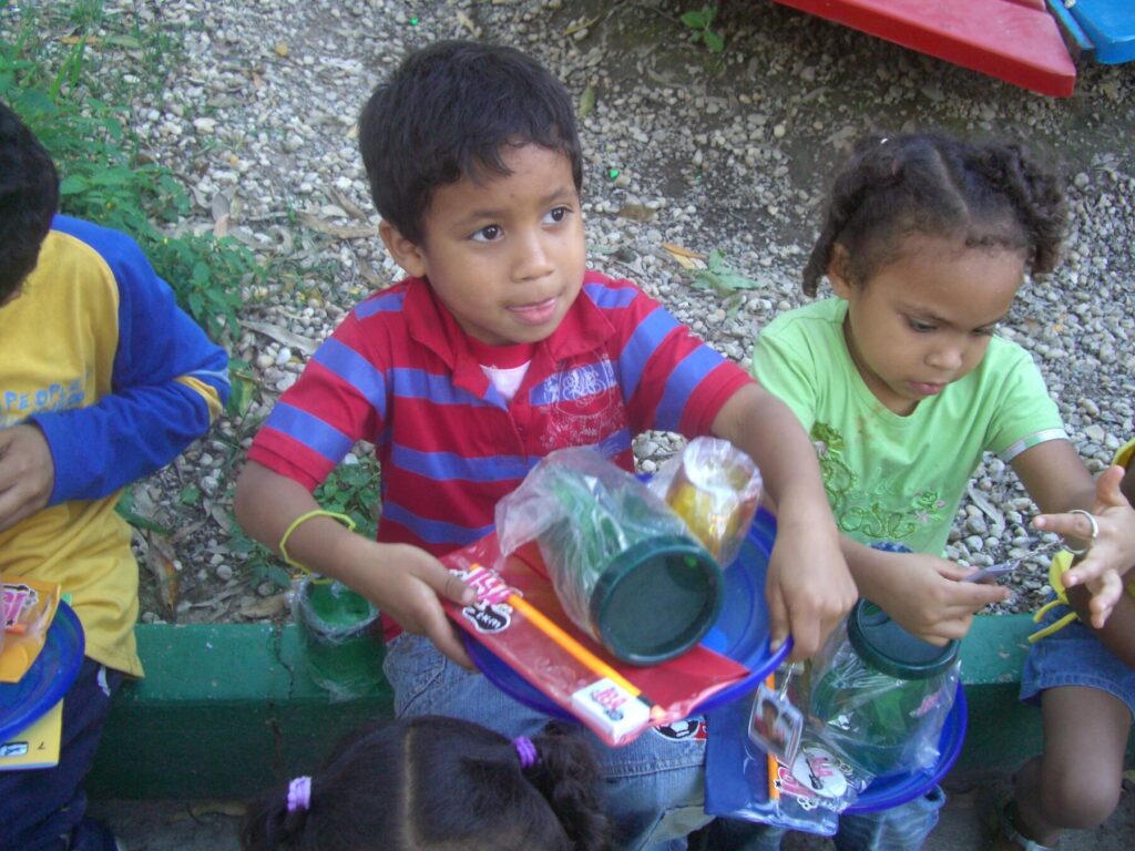 Children receiving toys and donated items at Hogares Bambi Venezuela.