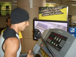 Román EL RO beside a treadmill during the Gold’s Gym solidarity challenge in Caracas in June 2008.