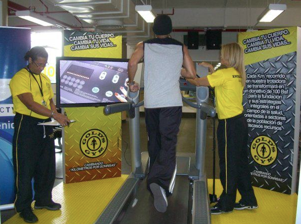 Treadmill station and Kilometers for Smiles campaign signage at Gold’s Gym Venezuela.