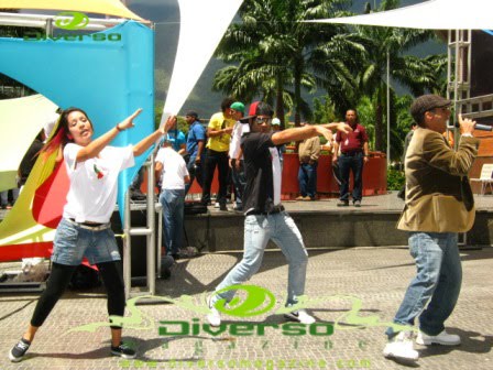 Roman EL RO performing alongside dancers on the outdoor stage.