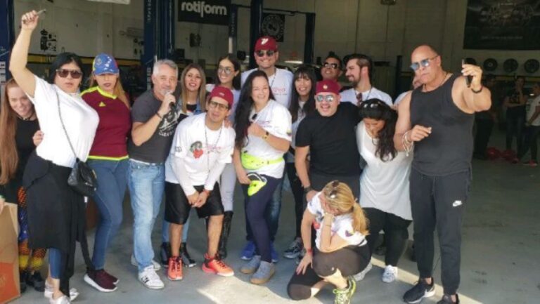 A diverse group of supporters posing together at the Doral donation drive.