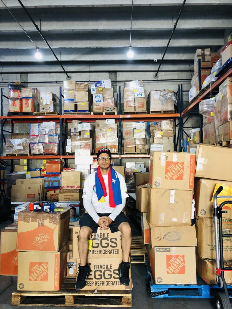 Volunteer among boxes at a logistics warehouse on March 23, 2019.