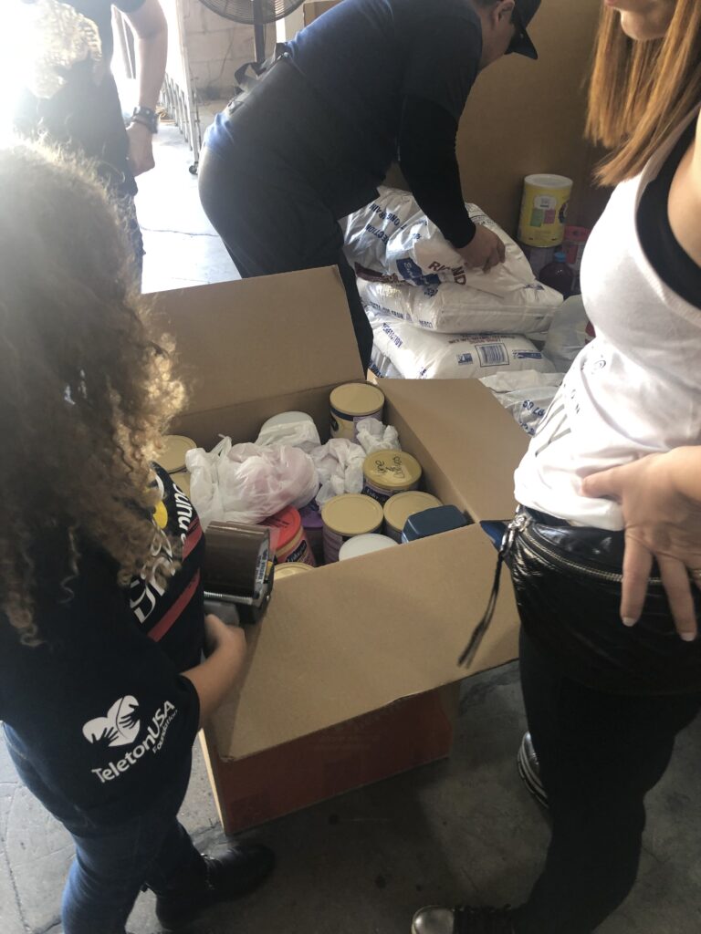 Food packages photographed among the collected provisions in a March 2019 warehouse.