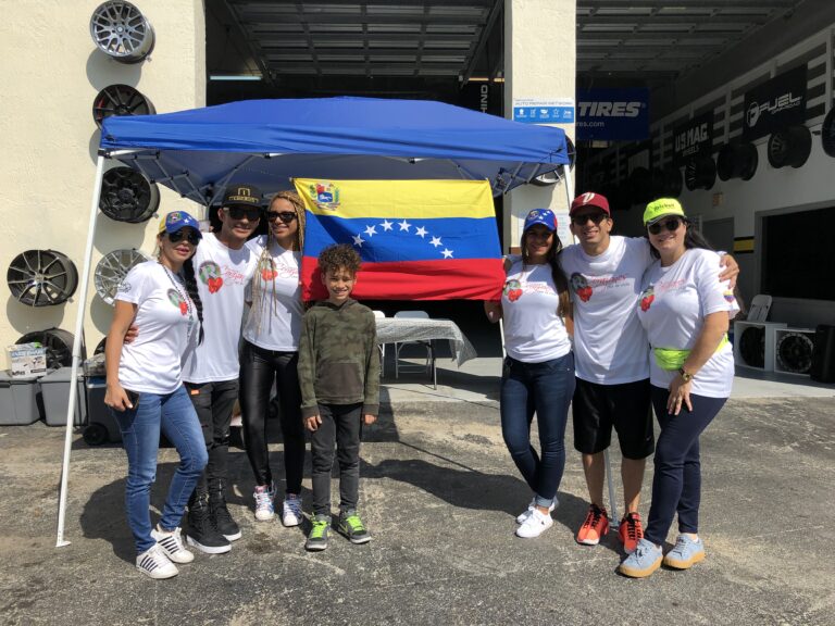Supporters standing in front of a Venezuelan flag outside the collection point.