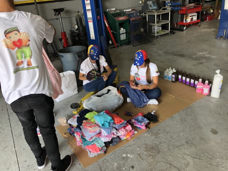 Stacks of boxes with donated goods inside La Ceiba Tire Shop.