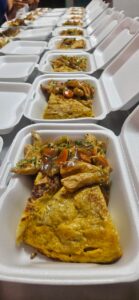 Rows of freshly prepared hot meals packaged for distribution in La Guaira.