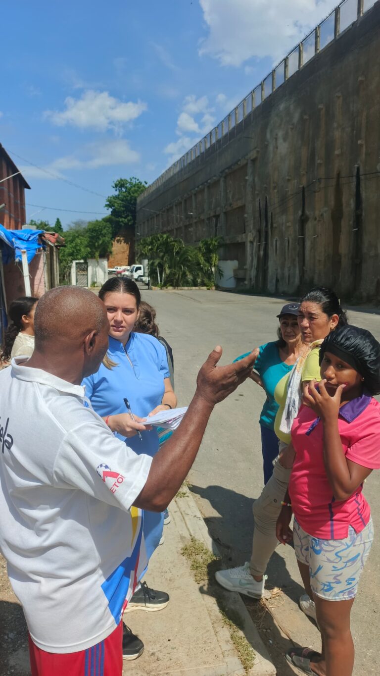 Team member speaking with community residents in La Guaira.